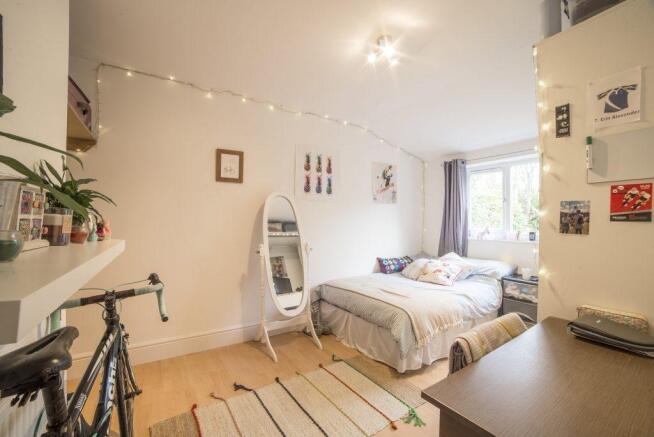 Bright, neatly styled double bedroom with a com...