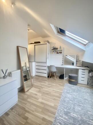 Bright, modern attic master bedroom with sloped...