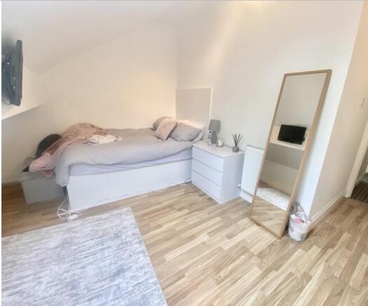 Bright, neatly presented bedroom with a comfort...