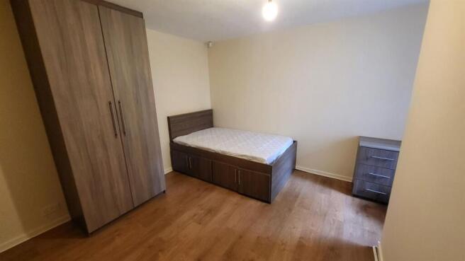 A bright and inviting double bedroom featuring ...