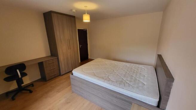 A neatly maintained bedroom featuring a single ...