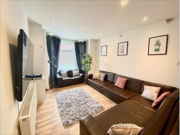 Contemporary living room with L-shaped leather ...