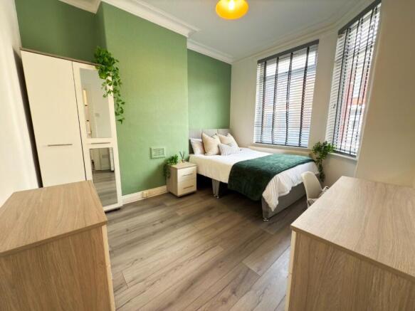 Bright, modern double bedroom with a comfortabl...