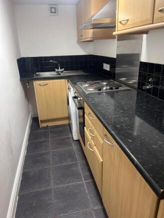 A modern kitchenette with stylish cabinetry and...