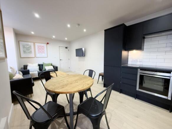 Modern open-plan living area with a round dinin...