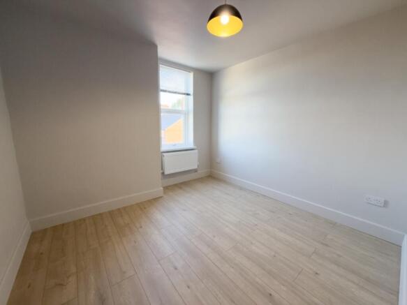 Bright, freshly painted single bedroom with a l...