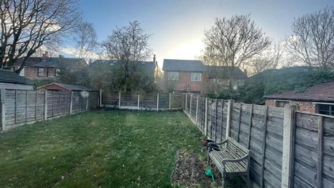 Well-kept rear garden with a level lawn, fenced...