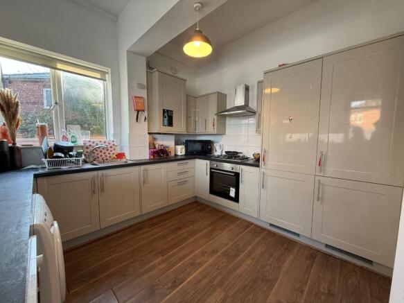Bright, modern kitchen with glossy fitted cabin...