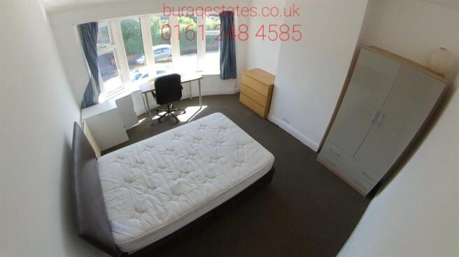 A well-maintained bedroom featuring a spacious ...