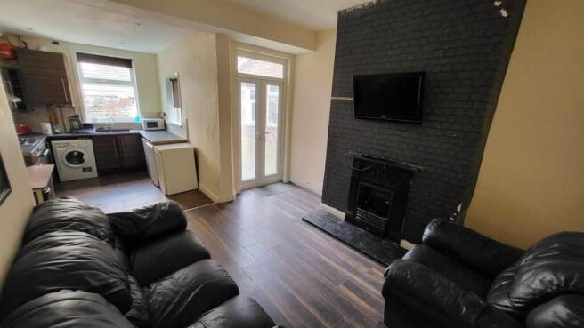 A spacious and inviting living room featuring m...