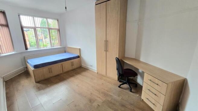 Bright, tidy bedroom with a large window, built...