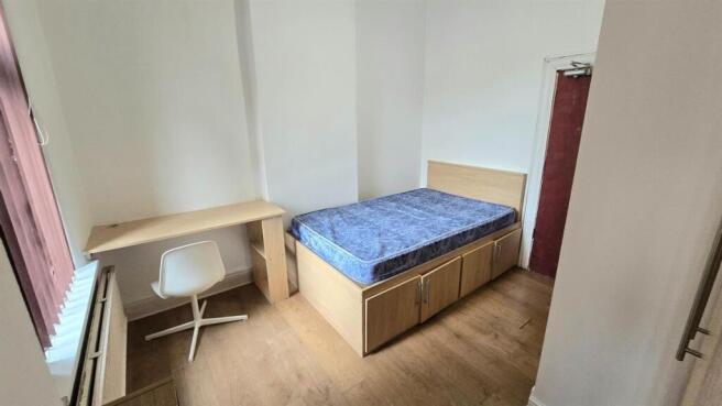 Bright, simply furnished bedroom with a raised ...