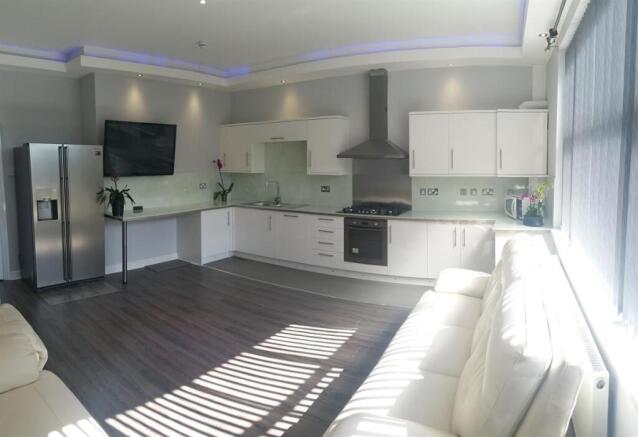 Bright, modern open-plan living area with a sle...