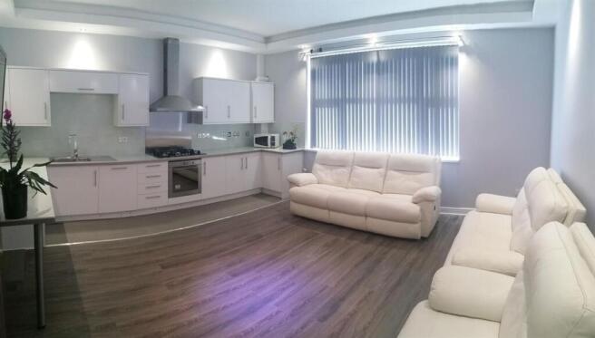 Bright, modern open-plan living area with a sle...