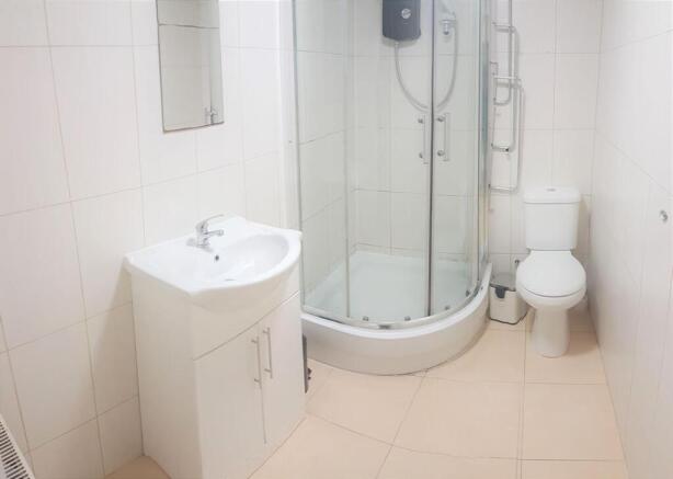 Bright, modern bathroom with a corner glass sho...