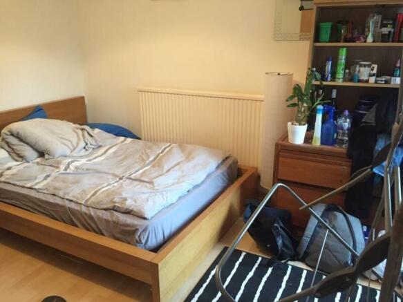 Bright, simply furnished double bedroom with a ...