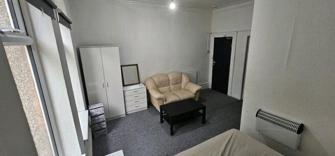 Bright, simply furnished double bedroom with la...