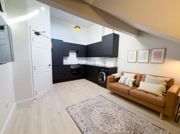 Bright open-plan living area with a modern fitt...