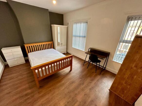Bright, tidy bedroom with wooden floor, a doubl...