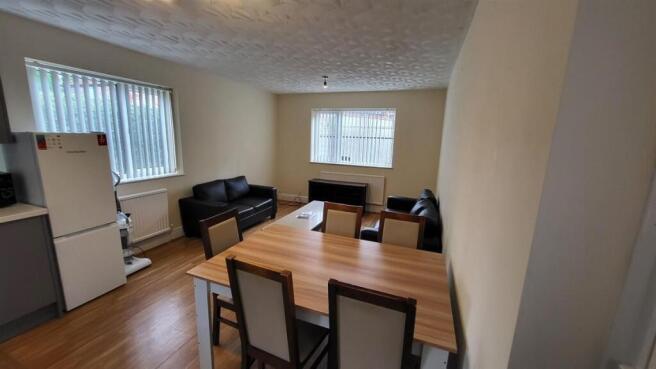 Bright, well-kept living area with a dining tab...