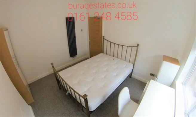 Bright, neutral double bedroom with a metal-fra...