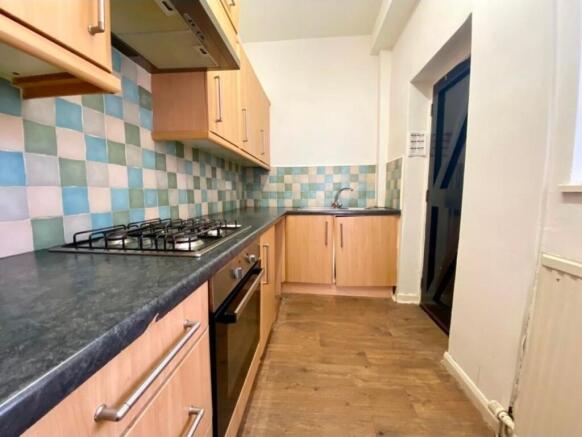 Bright fitted kitchen with modern wood-effect c...