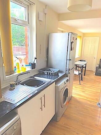 Bright galley-style kitchen with a large window...