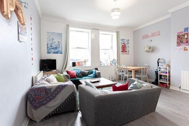 Bright and inviting living room with large wind...