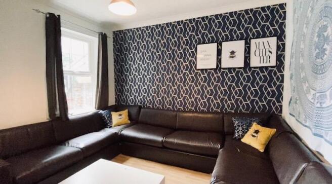 Bright, modern lounge with a large L-shaped lea...