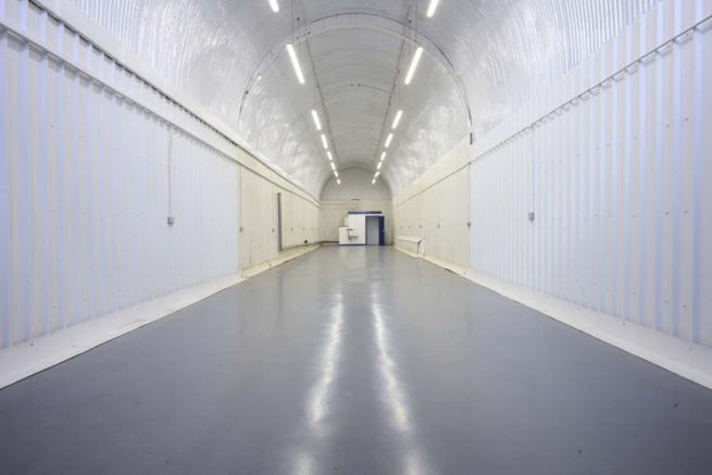 The front of an arch, with glazing on the bottom half and door allowing you to see into the arch interior.