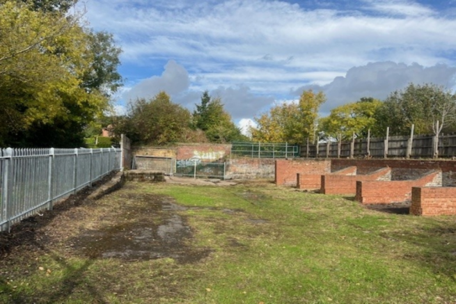 A large plot of land, with fencing around it.