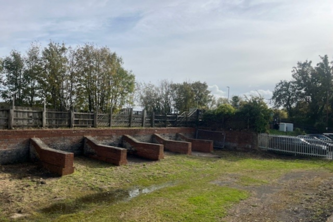 A large plot of land, with fencing around it.