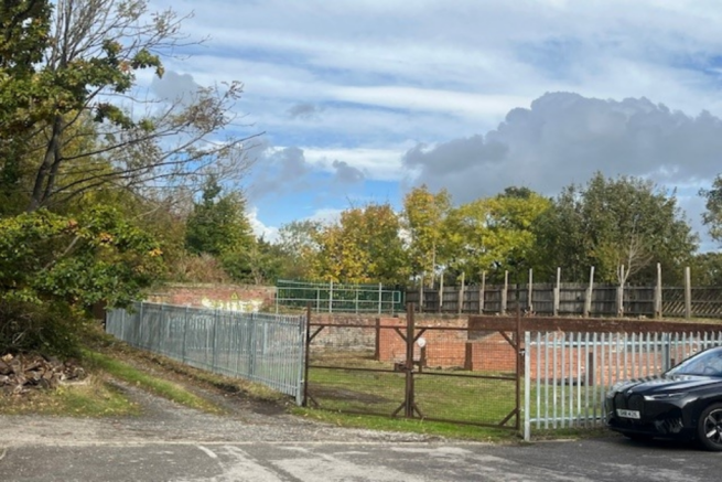 A large plot of land, with fencing around it.