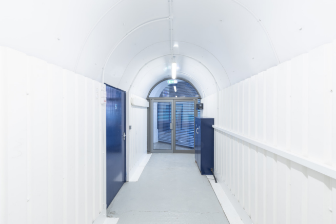 An empty arch with lining and glazing at the front, on the lower level only.