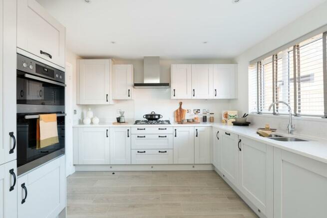 The large kitchen benefits from ample storage space