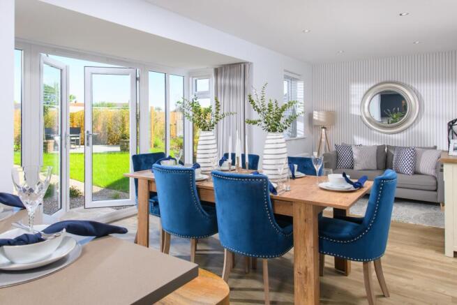 Open-plan kitchen/diner with glazed bay leading to garden in Bradgate style home