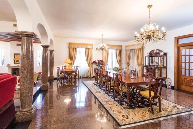 Elegant dining room with a long wooden table, chan
