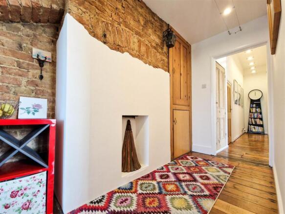 Hallway with exposed brick feature wall