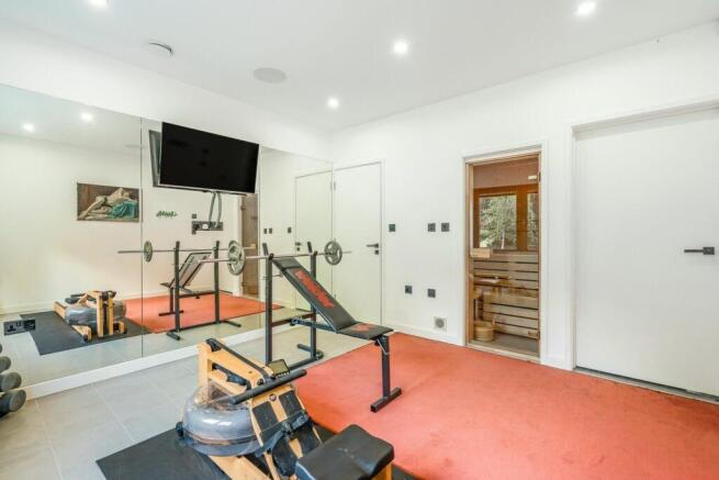 Private gym with mirrored walls, adjoining sauna,