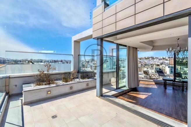 Modern rooftop terrace with large glass doors, off