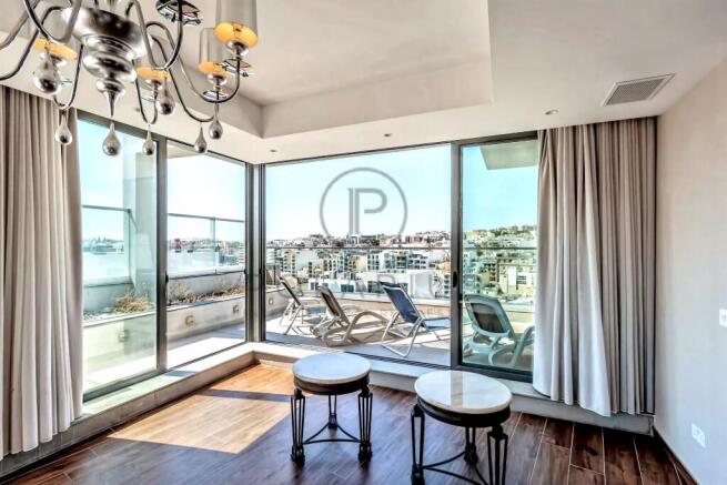 Bright room with floor-to-ceiling windows, two sma