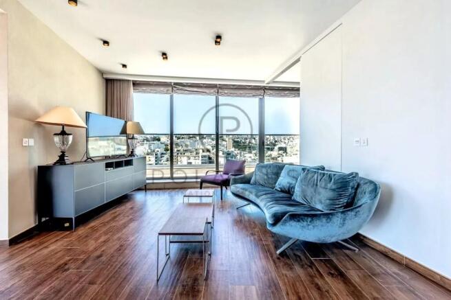 A modern living room with wooden flooring, featuri