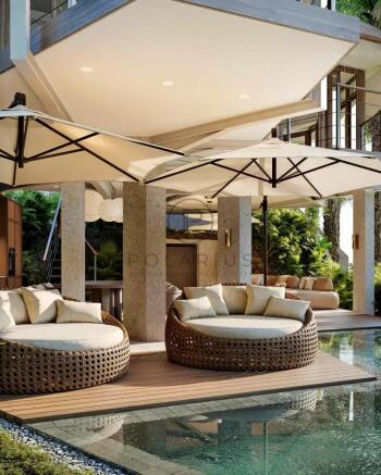 Luxurious poolside patio featuring round wicker lo