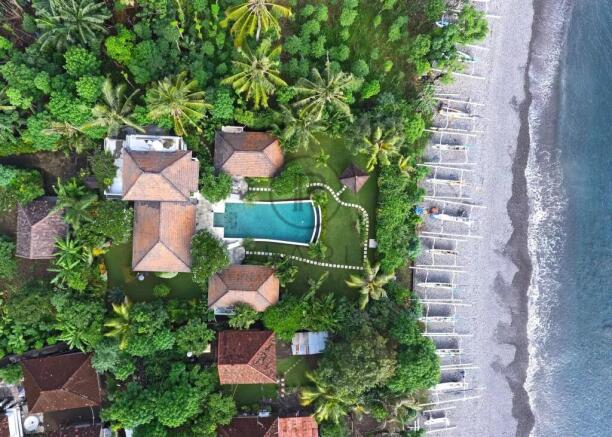 Aerial view of a coastal resort with red-roofed bu
