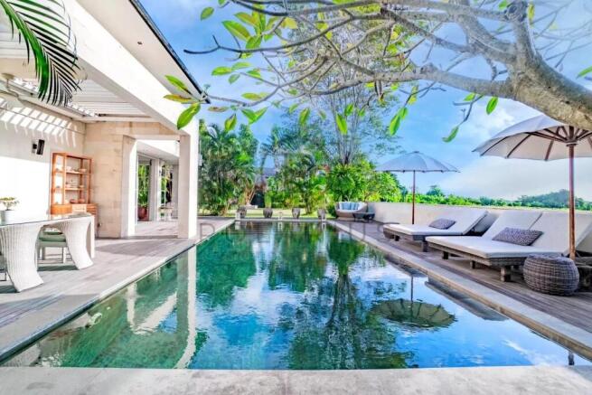 A serene outdoor space featuring a sleek swimming 