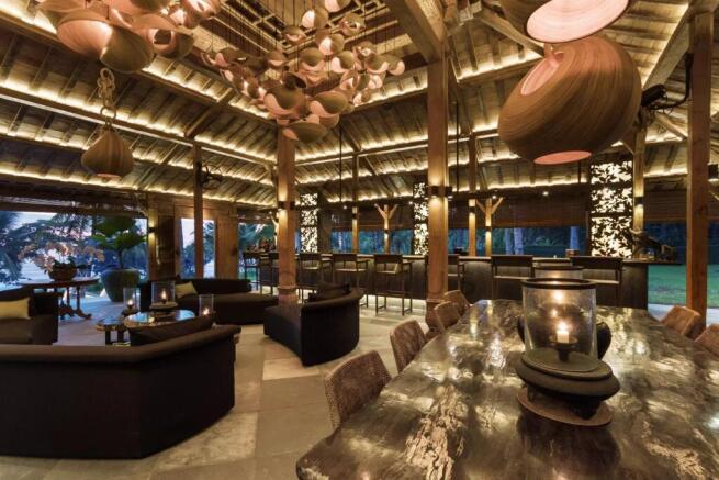 A stylish and warmly lit open-air lounge with wood