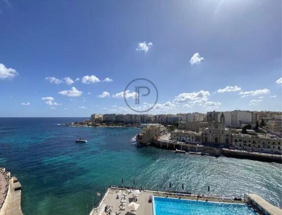 A coastal cityscape with vibrant blue waters, a sw