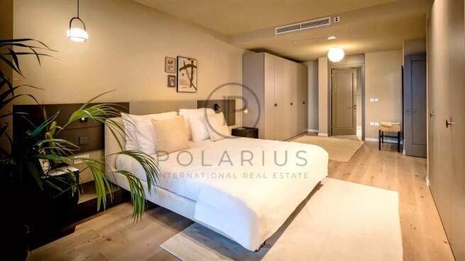 A modern, spacious bedroom with a cozy bed, minima