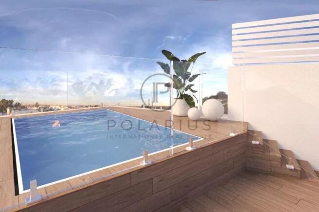 A modern rooftop pool with clear glass barriers, w