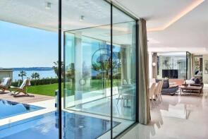 Luxurious open-plan living space with glass walls,